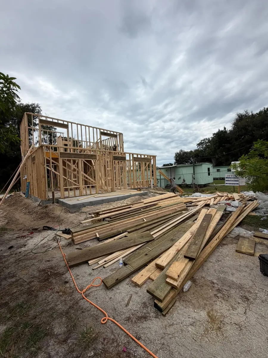 Wood framing for a new build with lumber stacked on site